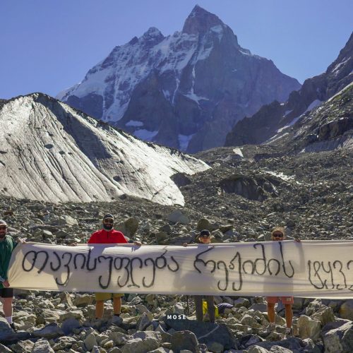 A demand for "hostages of the regime" to be freed. Photo taken by the famous "Mose", with Ushba in the background - one of the most notable peaks of the Caucasus Mountains. It is located in the Svaneti region of Georgia, just south of the border with the Kabardino-Balkaria region of Russia.